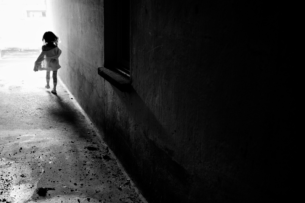 Girl running into the light in Switzerland