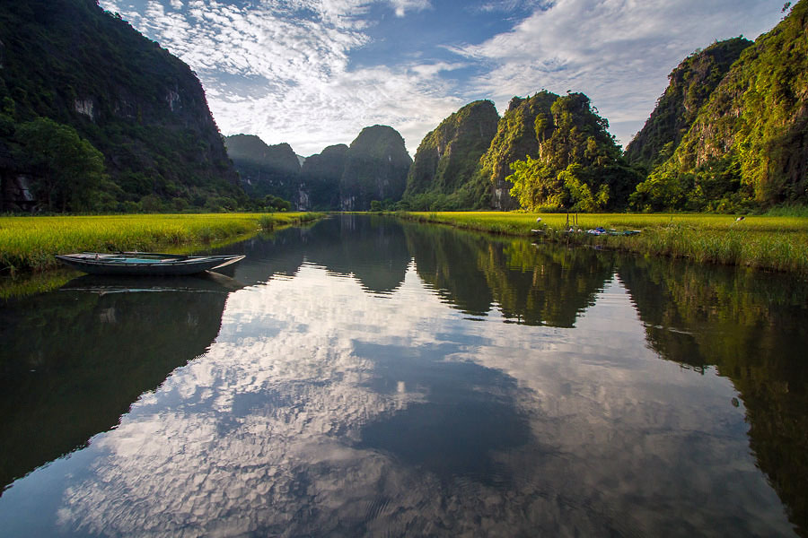 Boat on still water in the Tam Coc Rice Valley, Vietnam