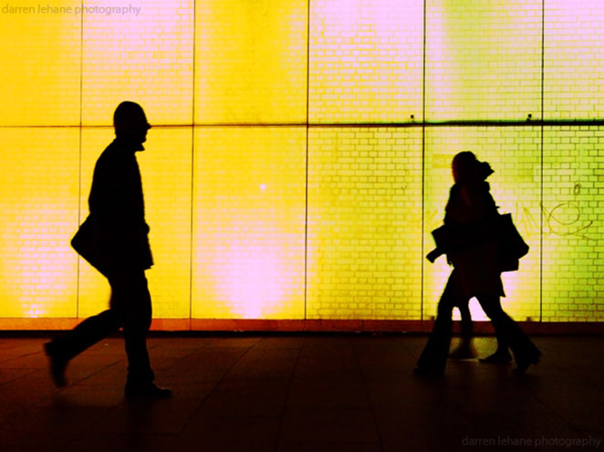 Silhouette of two strangers passing