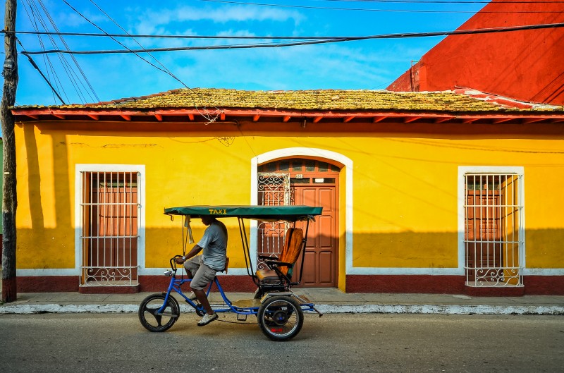 Taxi bike driving through Trinidad, Cuba